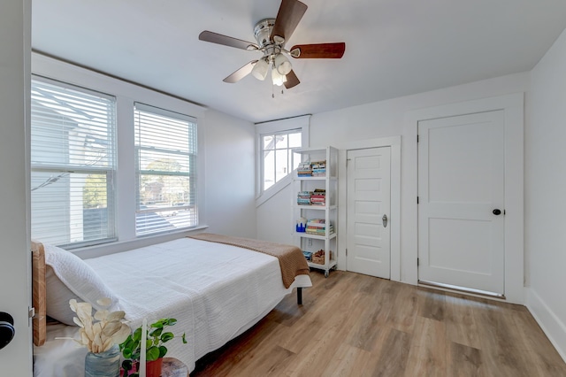 bedroom with light wood-type flooring and ceiling fan