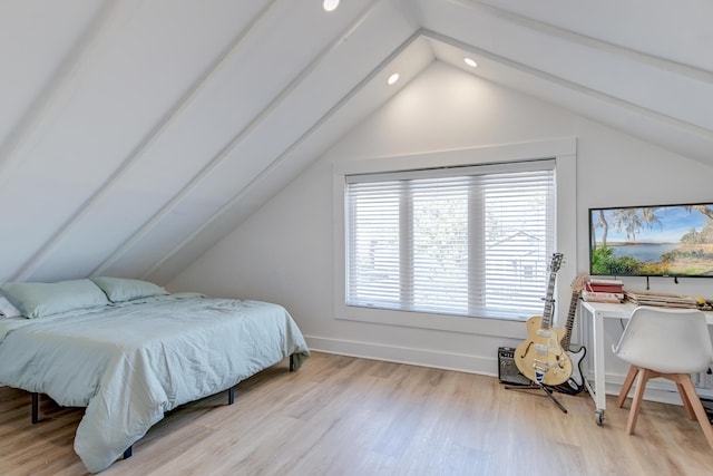 bedroom featuring vaulted ceiling and light hardwood / wood-style flooring