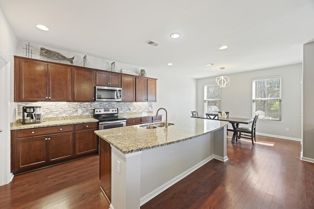 kitchen with dark wood-style floors, appliances with stainless steel finishes, a sink, and visible vents