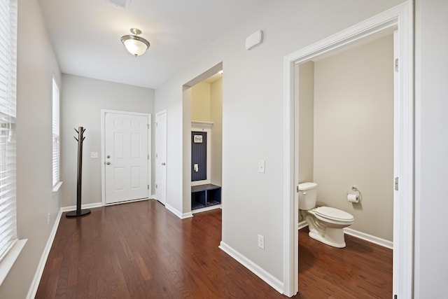 entrance foyer with baseboards and wood finished floors