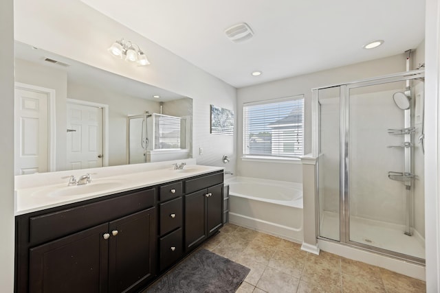 full bath with a garden tub, double vanity, visible vents, a stall shower, and a sink