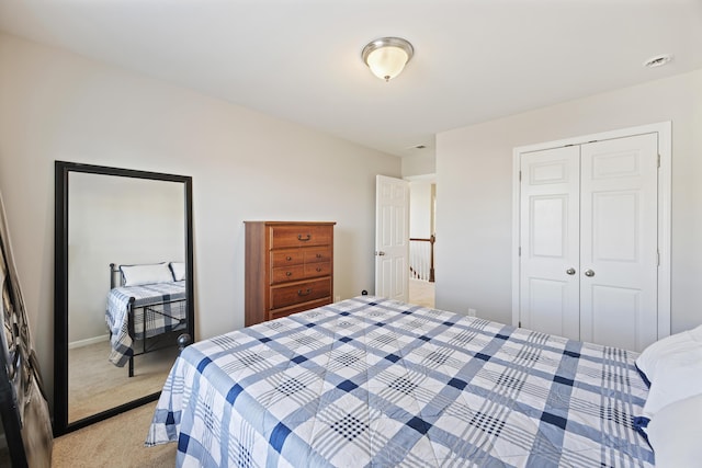 bedroom with a closet and light colored carpet