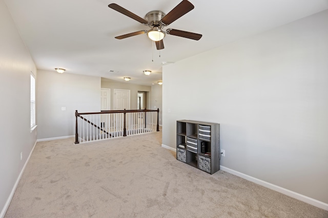 carpeted spare room featuring baseboards