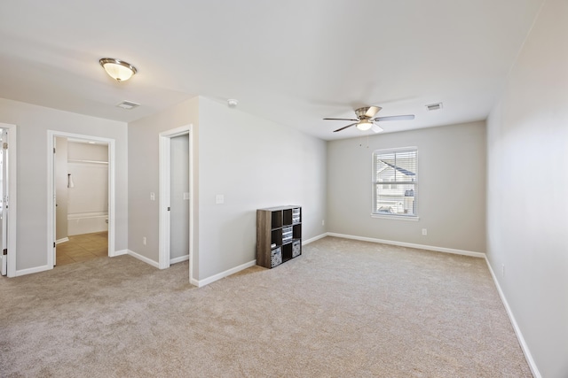 unfurnished living room featuring carpet floors, visible vents, ceiling fan, and baseboards