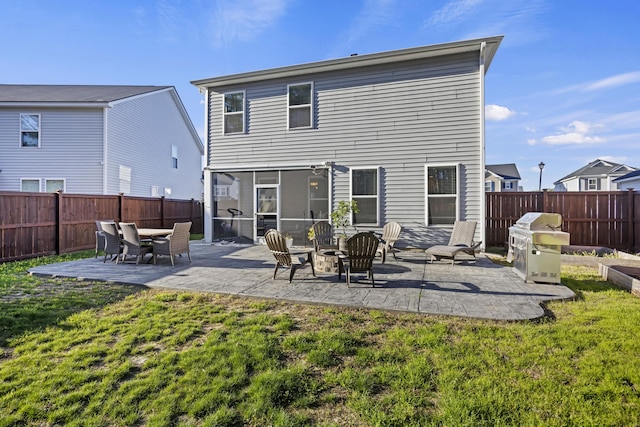 back of property featuring a patio area, a lawn, and a fenced backyard