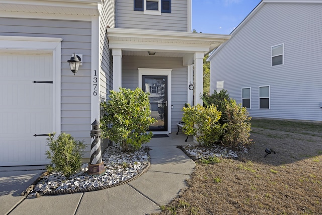 view of exterior entry featuring an attached garage