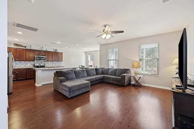 living room featuring dark wood finished floors, recessed lighting, visible vents, a ceiling fan, and baseboards