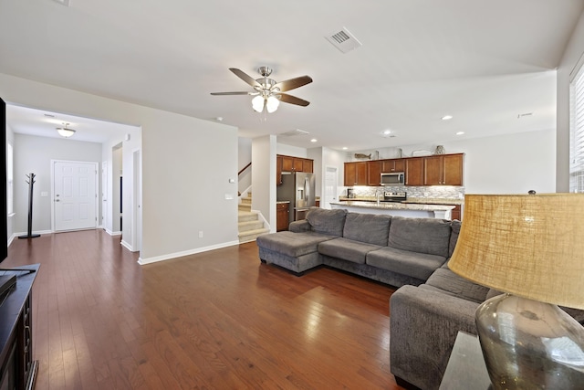 living area with visible vents, dark wood finished floors, baseboards, stairway, and recessed lighting