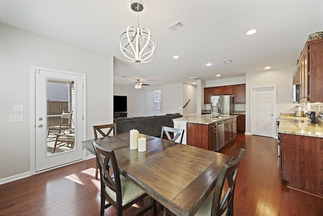 dining room featuring dark wood-style floors, recessed lighting, visible vents, baseboards, and ceiling fan with notable chandelier