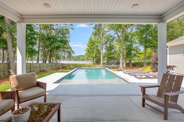 1607 Waterside Blvd, Moncks Corner, SC 29461 - view of swimming pool featuring a trampoline, a patio area, a fenced backyard, and a water view