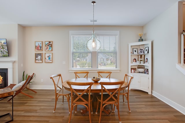 1607 Waterside Blvd, Moncks Corner, SC 29461 - dining area with light wood-type flooring, baseboards, and a glass covered fireplace