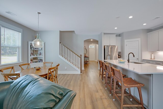 1607 Waterside Blvd, Moncks Corner, SC 29461 - kitchen featuring a sink, high end refrigerator, arched walkways, light countertops, and a kitchen breakfast bar