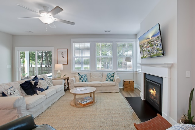 1607 Waterside Blvd, Moncks Corner, SC 29461 - living room with dark wood-style flooring, a glass covered fireplace, and a ceiling fan