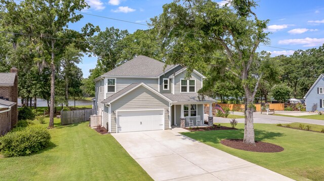 1607 Waterside Blvd, Moncks Corner, SC 29461 - traditional-style home featuring driveway, covered porch, a garage, and a shingled roof