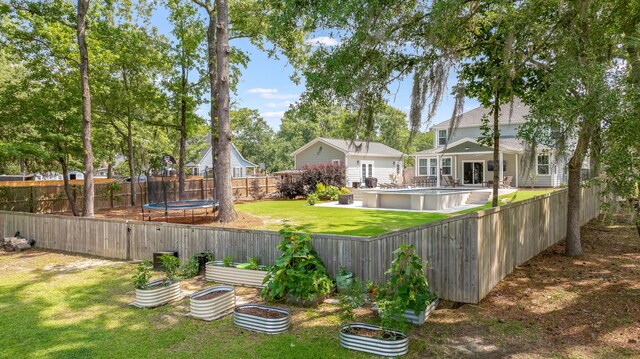 1607 Waterside Blvd, Moncks Corner, SC 29461 - view of yard with a trampoline and a vegetable garden