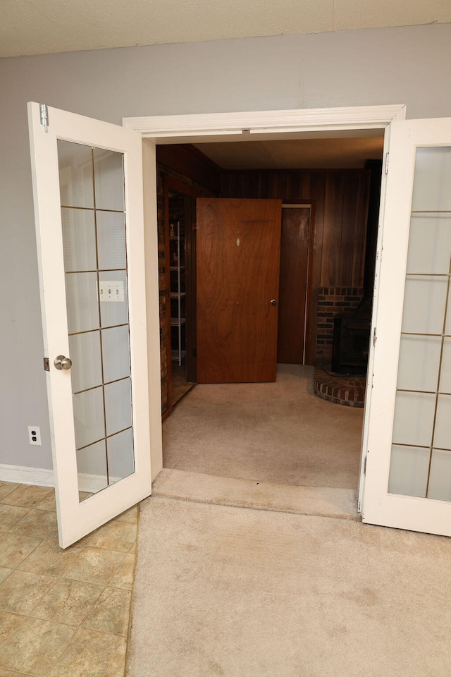 hall featuring light colored carpet