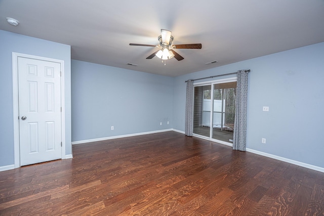 empty room with dark hardwood / wood-style flooring and ceiling fan