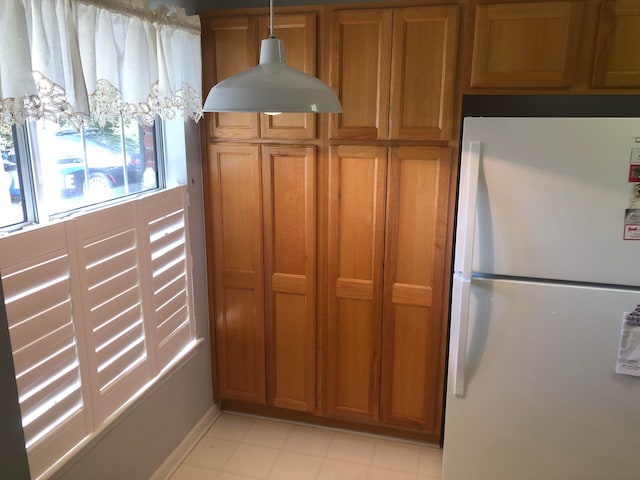 kitchen featuring pendant lighting and white refrigerator