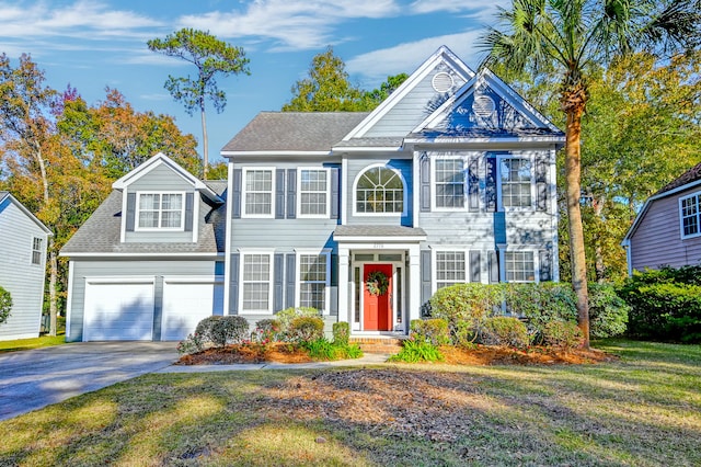 colonial inspired home featuring a garage and a front yard