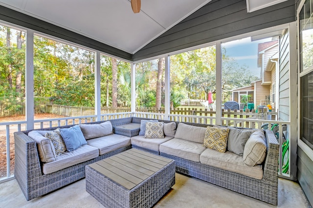 sunroom featuring plenty of natural light, lofted ceiling, and ceiling fan