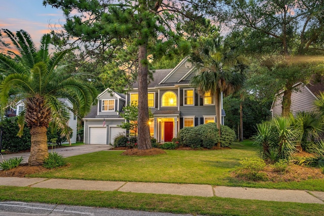 view of front of house with a yard and a garage