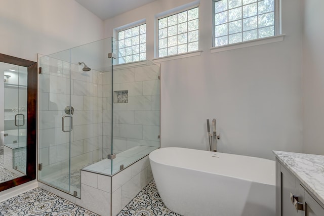 bathroom featuring tile patterned flooring, vanity, and independent shower and bath