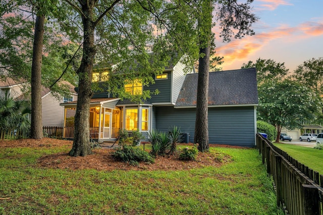 exterior space with a lawn and a sunroom