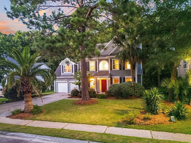 view of front of property with a lawn and a garage