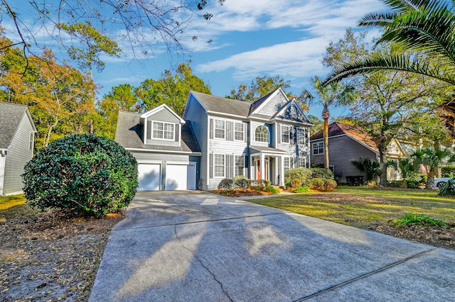 view of front of home featuring a front yard and a garage