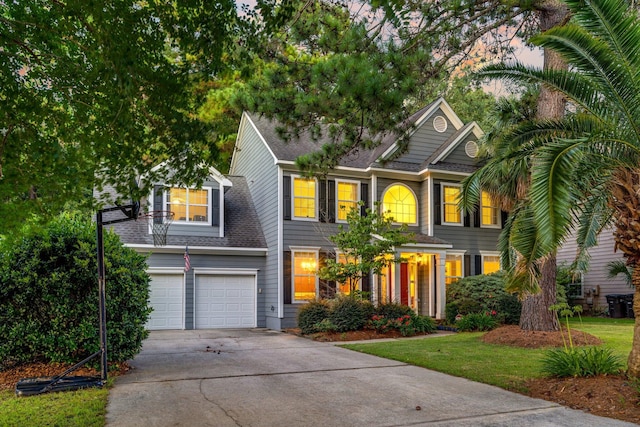 view of front facade with a yard and a garage