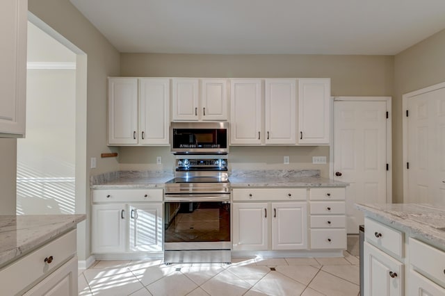 kitchen with white cabinets, appliances with stainless steel finishes, and light stone counters