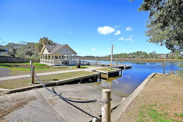 dock area with a gazebo and a water view