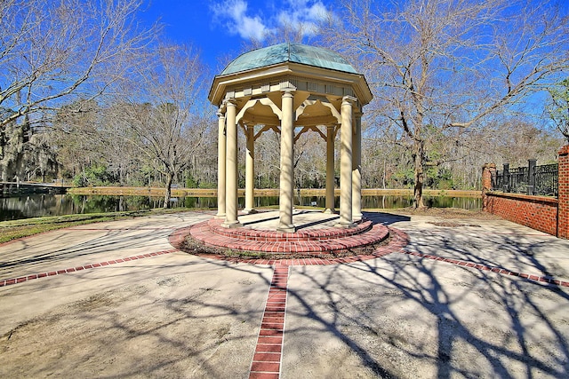 view of patio / terrace featuring a gazebo and a water view