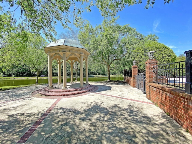 view of community with a gazebo and a water view