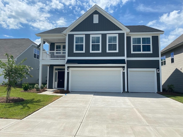 view of front of property with a garage, a balcony, and a front lawn