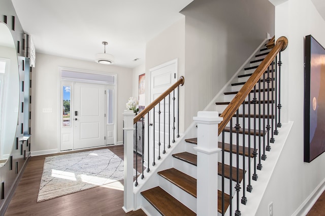 entryway with dark hardwood / wood-style flooring