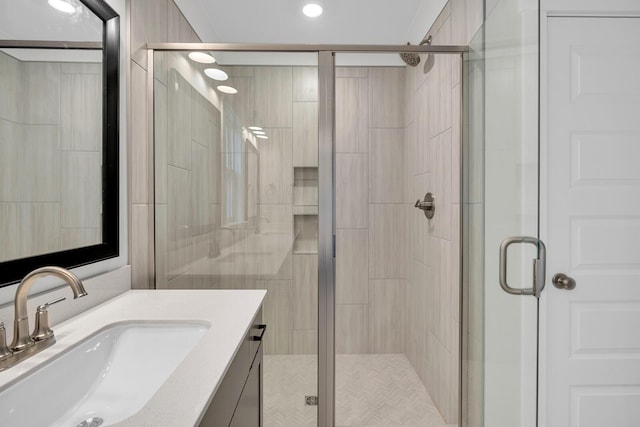 bathroom with vanity and a shower with shower door