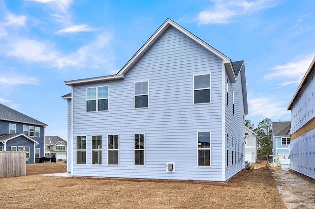 back of property featuring a lawn