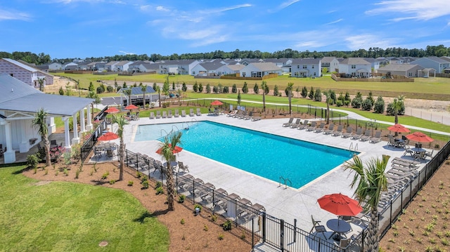 view of swimming pool with a patio area and a lawn