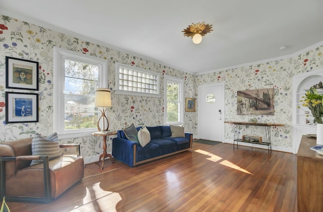 living room with crown molding, dark hardwood / wood-style floors, and a healthy amount of sunlight