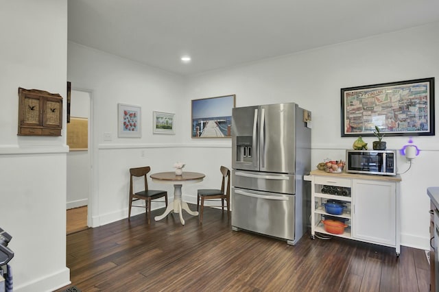 kitchen featuring dark hardwood / wood-style flooring and stainless steel appliances