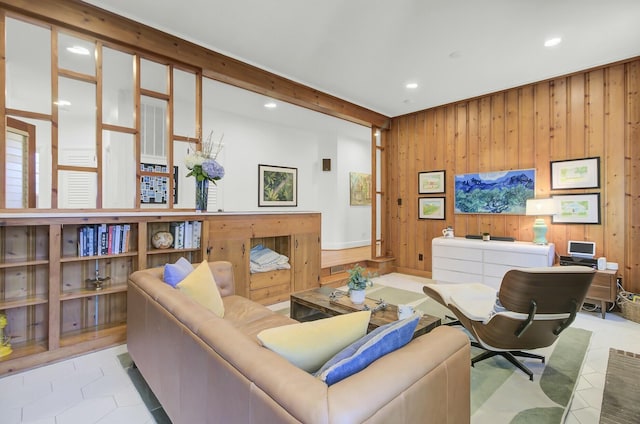 tiled living room featuring wooden walls