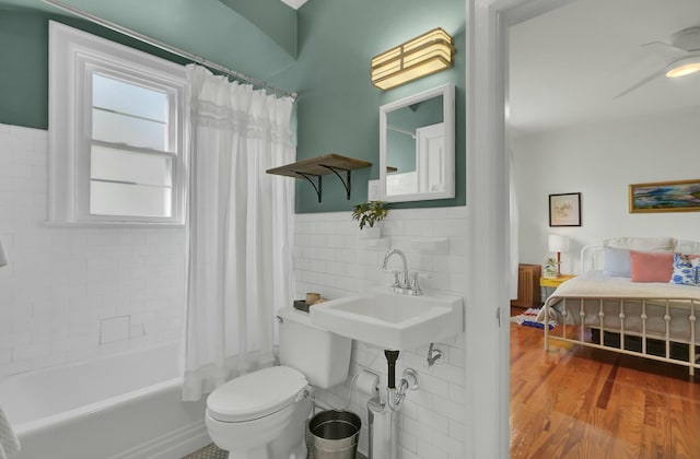 bathroom with wood-type flooring, shower / tub combo, ceiling fan, and toilet