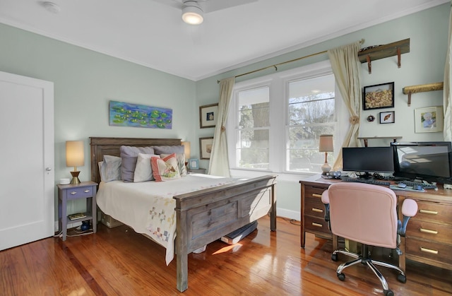 bedroom with crown molding and hardwood / wood-style flooring