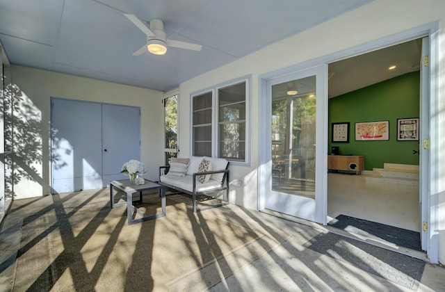 sunroom featuring ceiling fan, lofted ceiling, and plenty of natural light