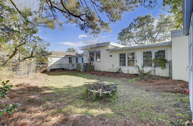 rear view of house featuring a yard