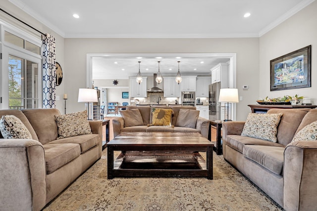 living area with ornamental molding and recessed lighting