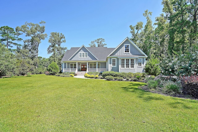 view of front facade featuring a porch, board and batten siding, and a front lawn