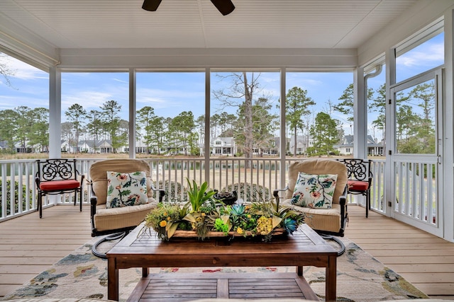 sunroom featuring a ceiling fan