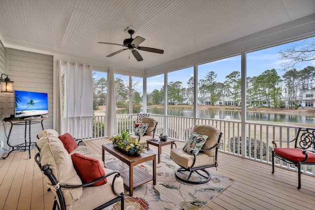 sunroom with a water view and a ceiling fan